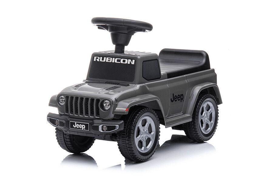 Een speelgoedauto voor kinderen waarop ze kunnen zitten in een grijs Jeep model - zijaanzicht